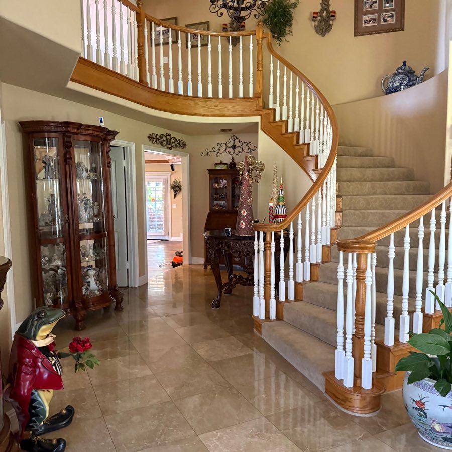 Estate foyer with curved staircase, spotless travertine floors